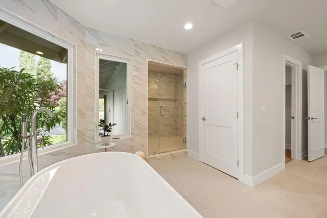 a view of a bedroom with a bed and glass door