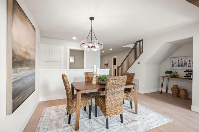 a view of a dining room with furniture wooden floor and a chandelier