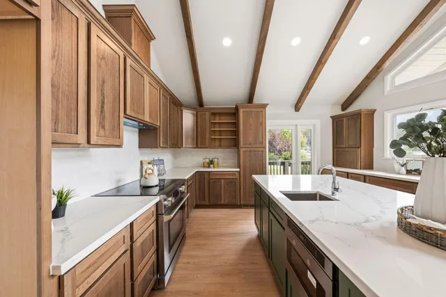 a kitchen with stainless steel appliances granite countertop lots of counter space and a sink