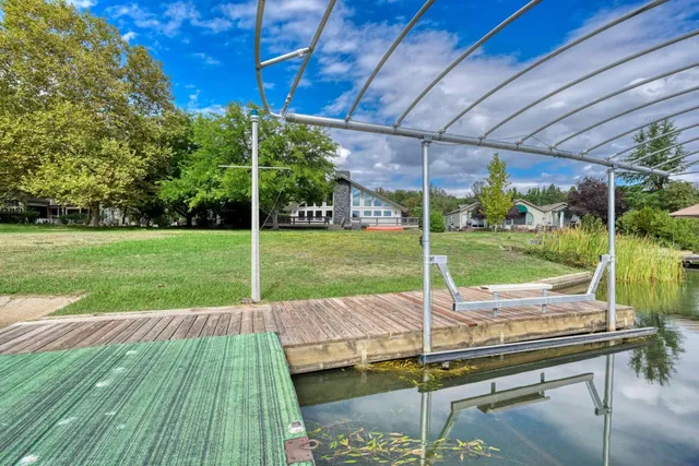 a view of a backyard with wooden floor patio and yard