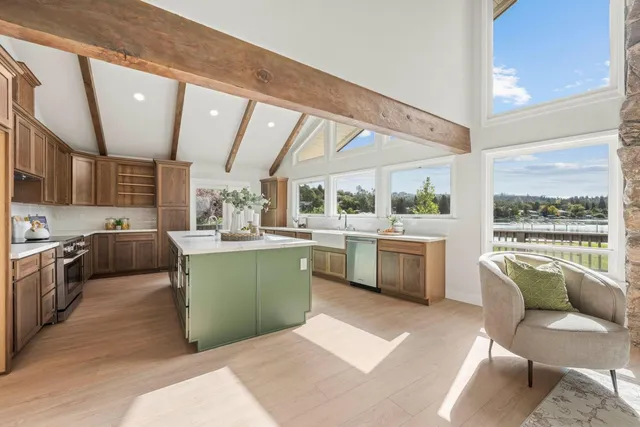a kitchen with a sink cabinets and wooden floor