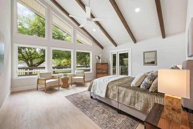 a bed sitting in a bedroom next to a large window