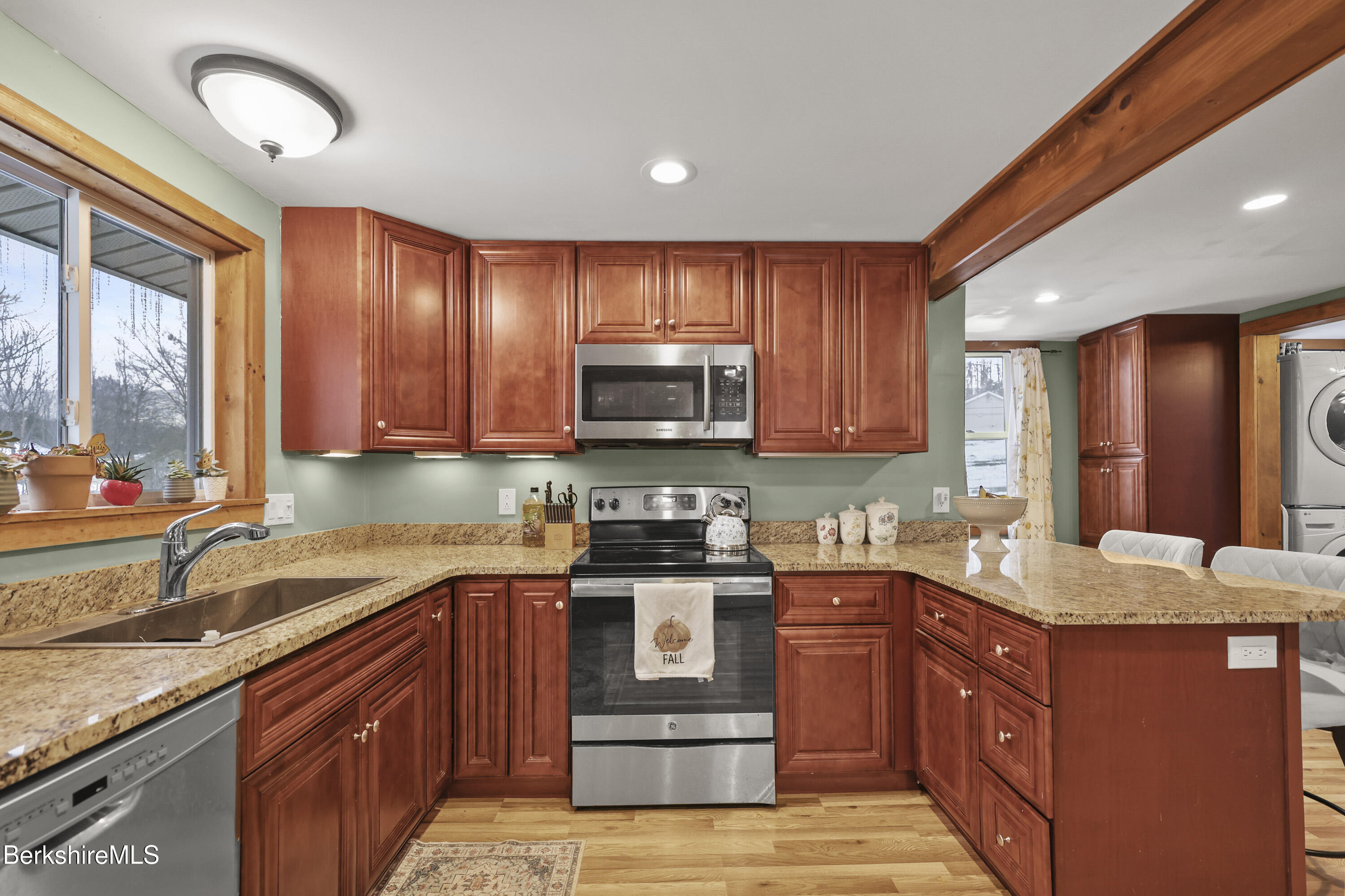 55 Newton Avenue Pittsfield, MA 01201 - Photo 13 of 30 a kitchen with stainless steel appliances granite countertop wooden cabinets a stove top oven a sink and dishwasher
