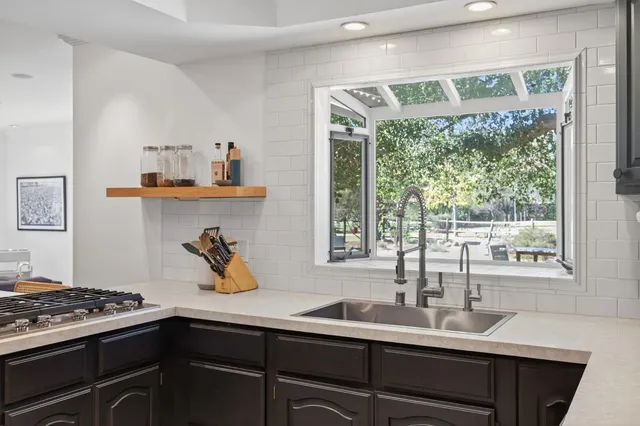 a kitchen with a sink and a stove