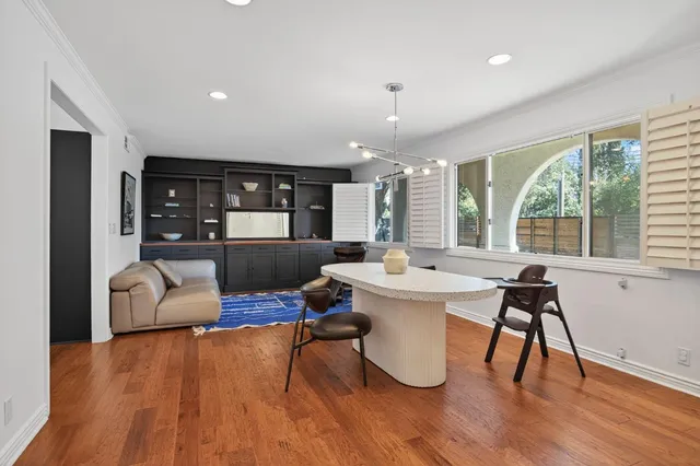 a view of a dining room with furniture window and wooden floor