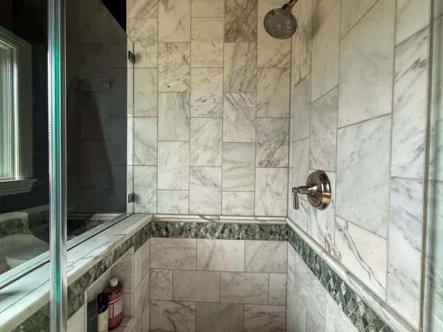 a bathroom with a bathtub and shower