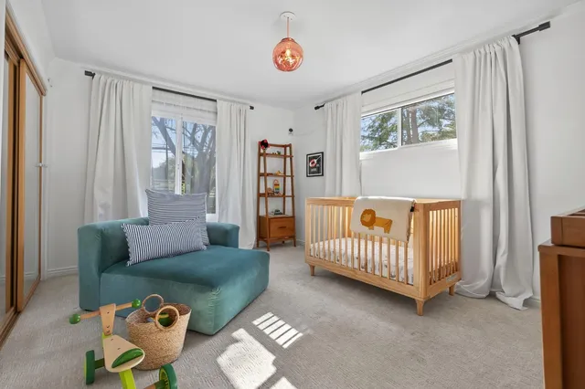a bedroom with furniture and a window