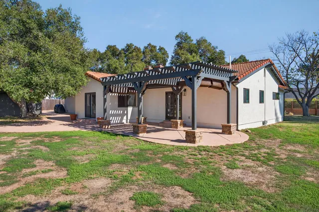 a view of a house with backyard porch and sitting area