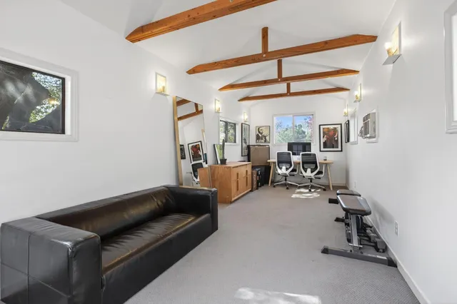 a living room with furniture a ceiling fan and a window