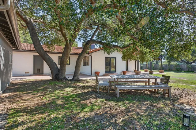 a view of a house with backyard and sitting area