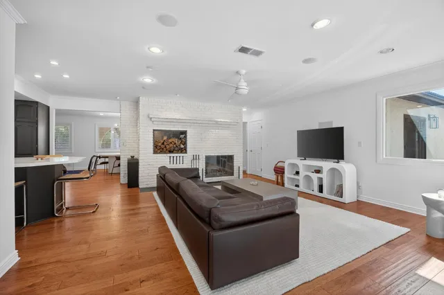 a living room with fireplace furniture and a flat screen tv