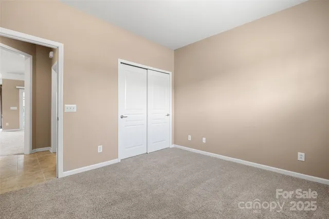 an empty room with closet area
