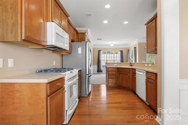a kitchen with stainless steel appliances granite countertop a stove and a sink