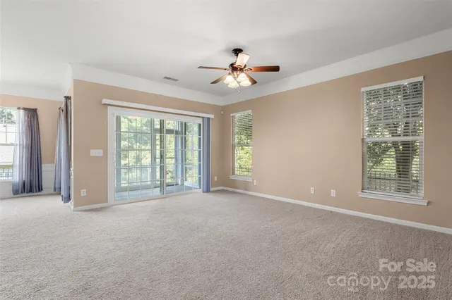 a view of a livingroom with a ceiling fan and window