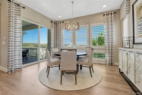 a dining room with furniture windows and wooden floor
