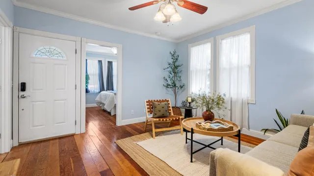 a living room with furniture and wooden floor