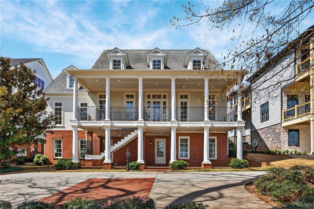 a front view of a residential apartment building with a yard