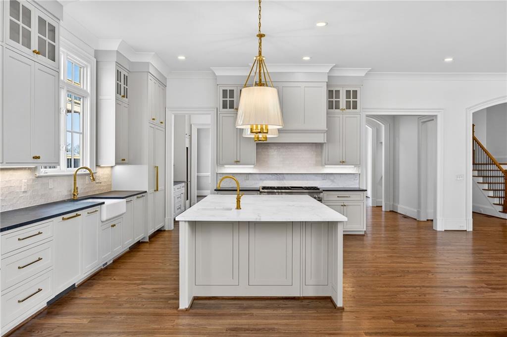 2147 Cooper Lake Road Southeast Smyrna, GA 30080 - Photo 11 of 65 a large kitchen with stainless steel appliances kitchen island granite countertop a sink and cabinets