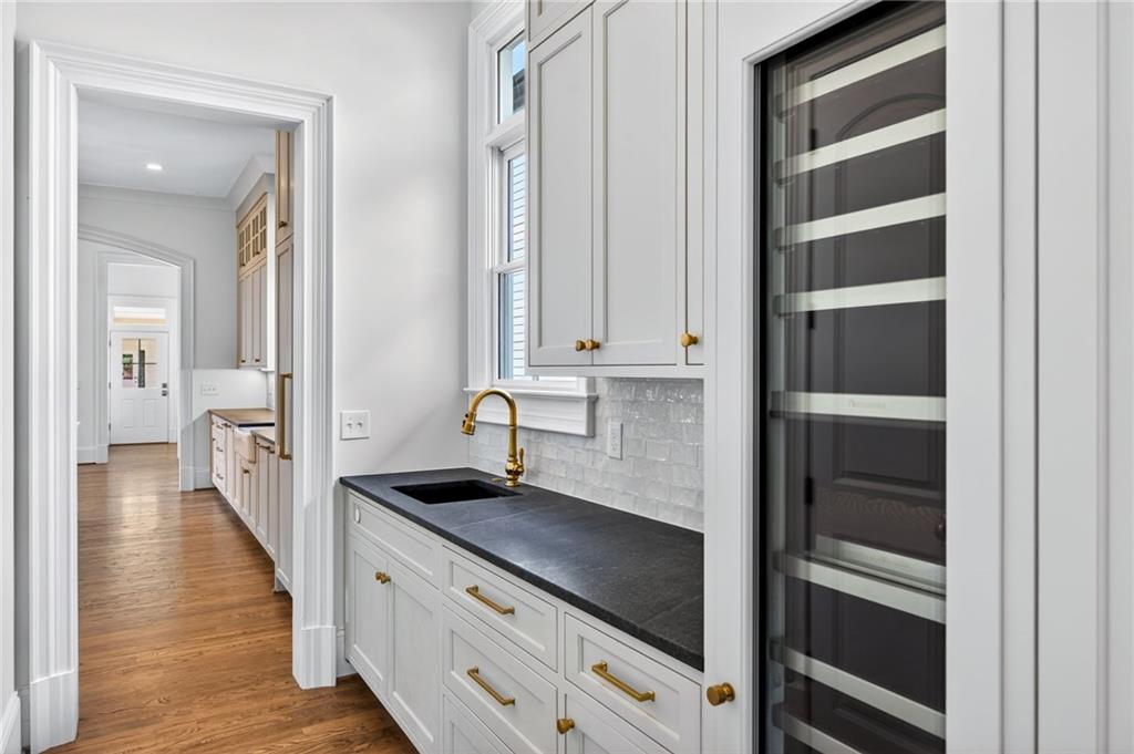 2147 Cooper Lake Road Southeast Smyrna, GA 30080 - Photo 16 of 65 a view of a kitchen with an empty space and wooden floor
