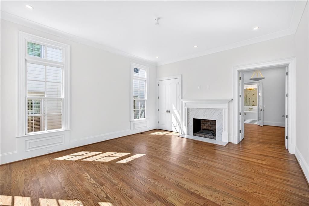 2147 Cooper Lake Road Southeast Smyrna, GA 30080 - Photo 20 of 65 a view of empty room with wooden floor and fireplace