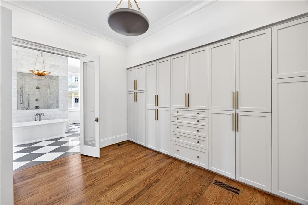2147 Cooper Lake Road Southeast Smyrna, GA 30080 - Photo 22 of 65 a view of a hallway with wooden floor and cabinet