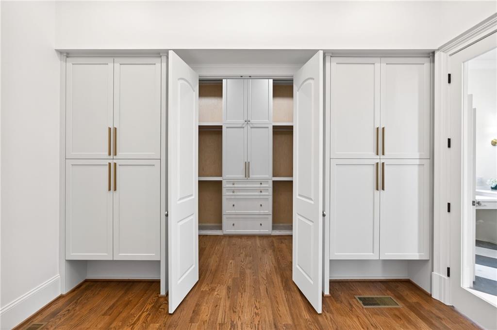 2147 Cooper Lake Road Southeast Smyrna, GA 30080 - Photo 23 of 65 a view of walk in closet with wooden floor