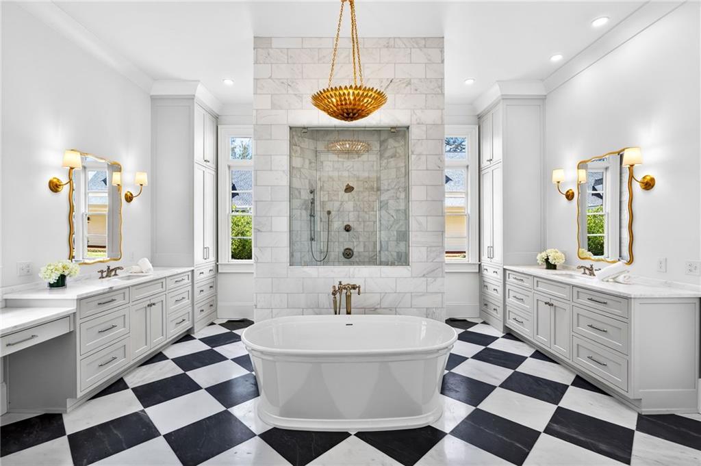 2147 Cooper Lake Road Southeast Smyrna, GA 30080 - Photo 24 of 65 a spacious bathroom with a sink a mirror a bathtub and a shower