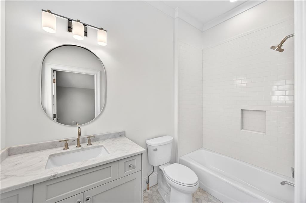 2147 Cooper Lake Road Southeast Smyrna, GA 30080 - Photo 37 of 65 a bathroom with a toilet a sink and mirror