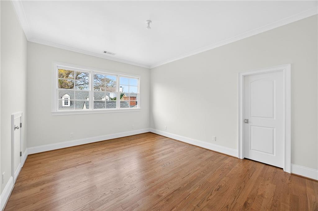 2147 Cooper Lake Road Southeast Smyrna, GA 30080 - Photo 38 of 65 an empty room with wooden floor and window