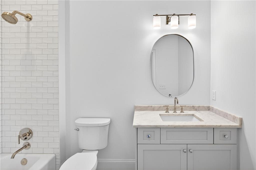 2147 Cooper Lake Road Southeast Smyrna, GA 30080 - Photo 40 of 65 a bathroom with a sink a toilet and a mirror