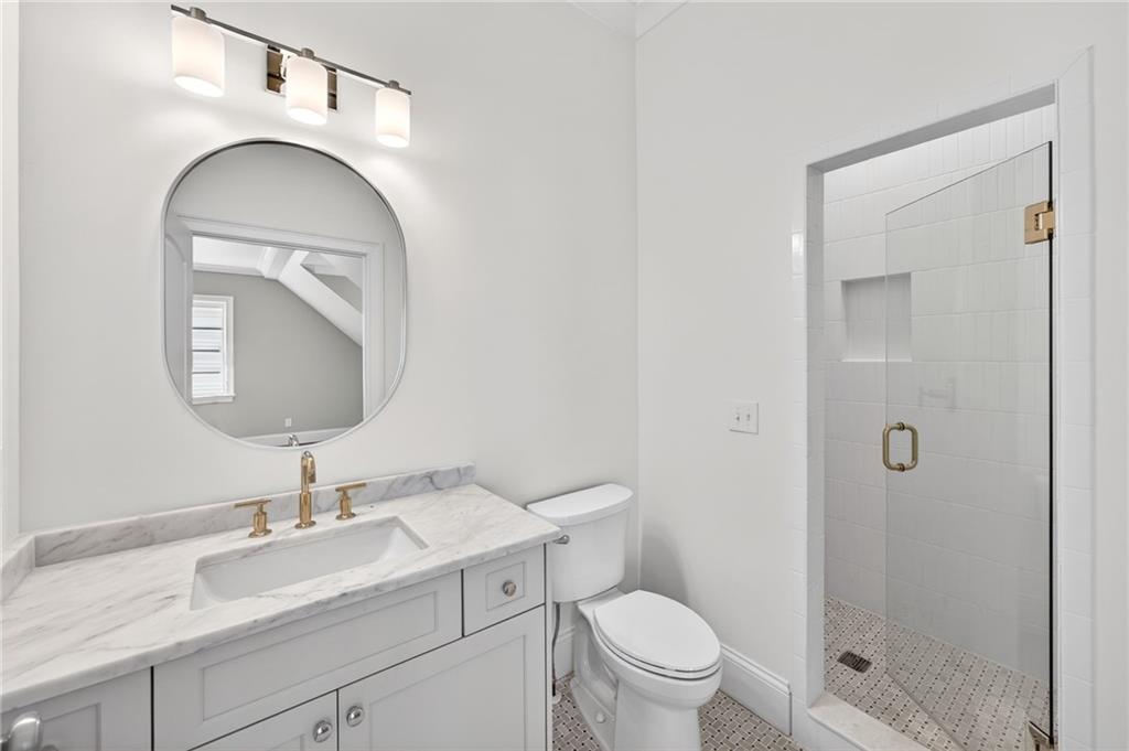 2147 Cooper Lake Road Southeast Smyrna, GA 30080 - Photo 43 of 65 a bathroom with a sink a toilet and shower
