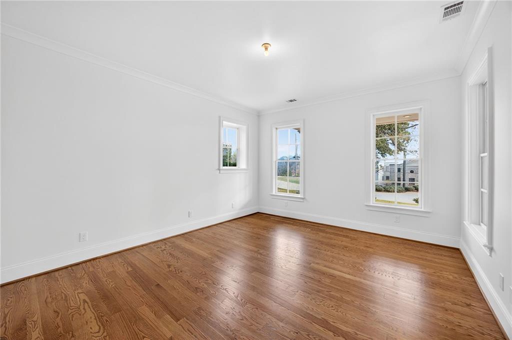 2147 Cooper Lake Road Southeast Smyrna, GA 30080 - Photo 47 of 65 an empty room with wooden floor and windows