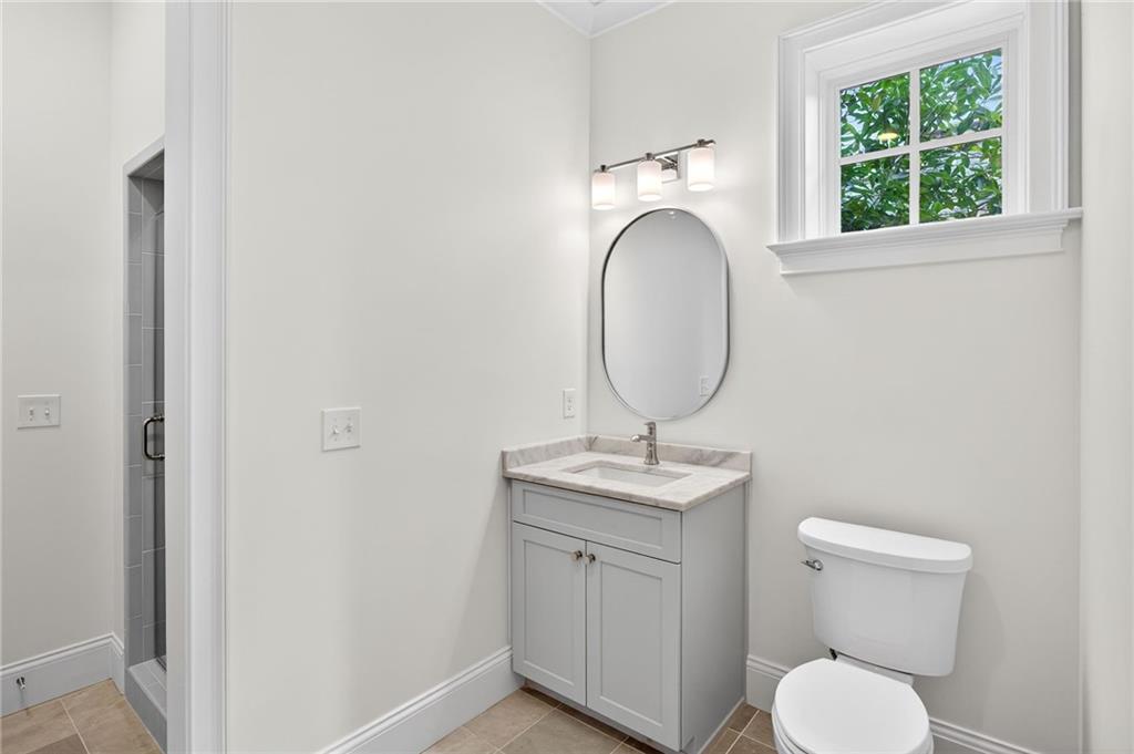 2147 Cooper Lake Road Southeast Smyrna, GA 30080 - Photo 49 of 65 a bathroom with a toilet a sink and a mirror