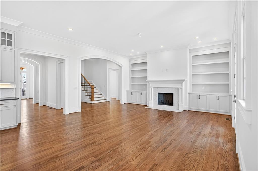 2147 Cooper Lake Road Southeast Smyrna, GA 30080 - Photo 5 of 65 a view of a livingroom with wooden floor and a fireplace