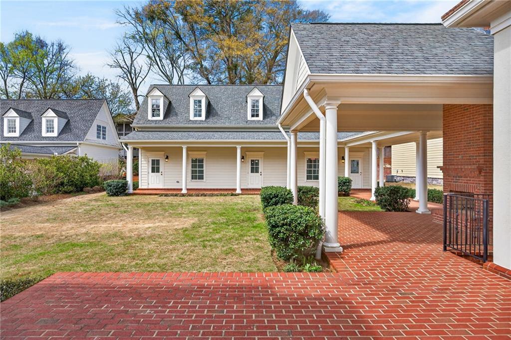 2147 Cooper Lake Road Southeast Smyrna, GA 30080 - Photo 62 of 65 front view of a brick house with a small yard