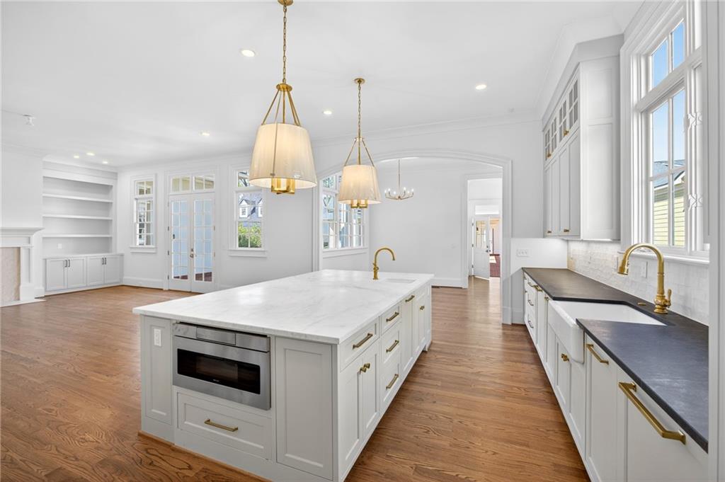 2147 Cooper Lake Road Southeast Smyrna, GA 30080 - Photo 8 of 65 a large kitchen with kitchen island a stove a sink a center island and windows
