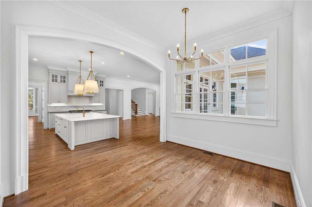 2147 Cooper Lake Road Southeast Smyrna, GA 30080 - Photo 10 of 65 a large white kitchen with granite countertop a stove top oven a sink dishwasher with a dining table and chairs