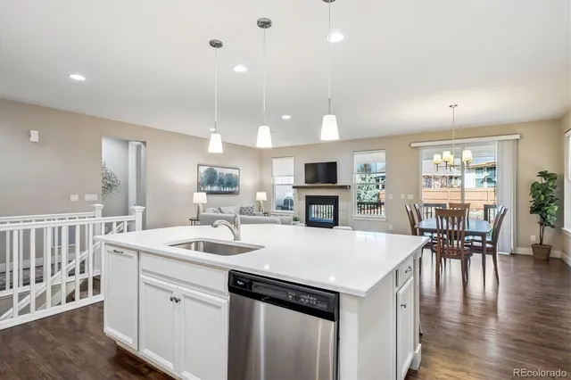 a kitchen with a table chairs microwave and cabinets