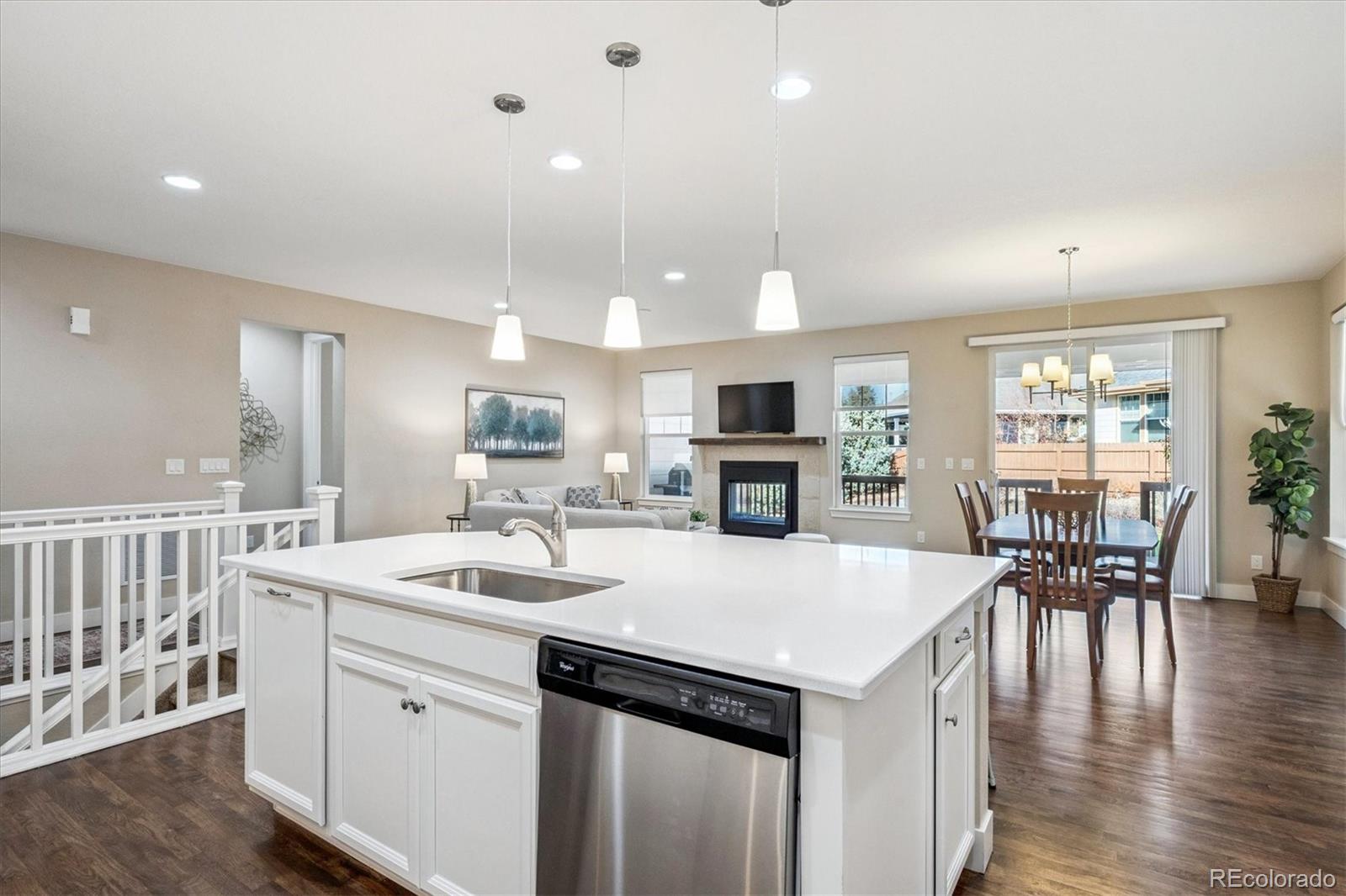 6667 Club Villa Road Parker, CO 80134 - Photo 12 of 50 a kitchen with a table chairs microwave and cabinets