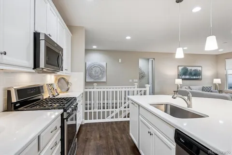 a kitchen that has a sink and a stove