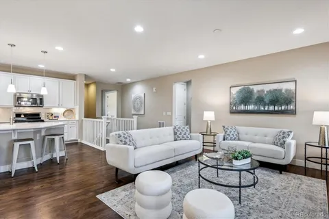 a living room with furniture and a wooden floor