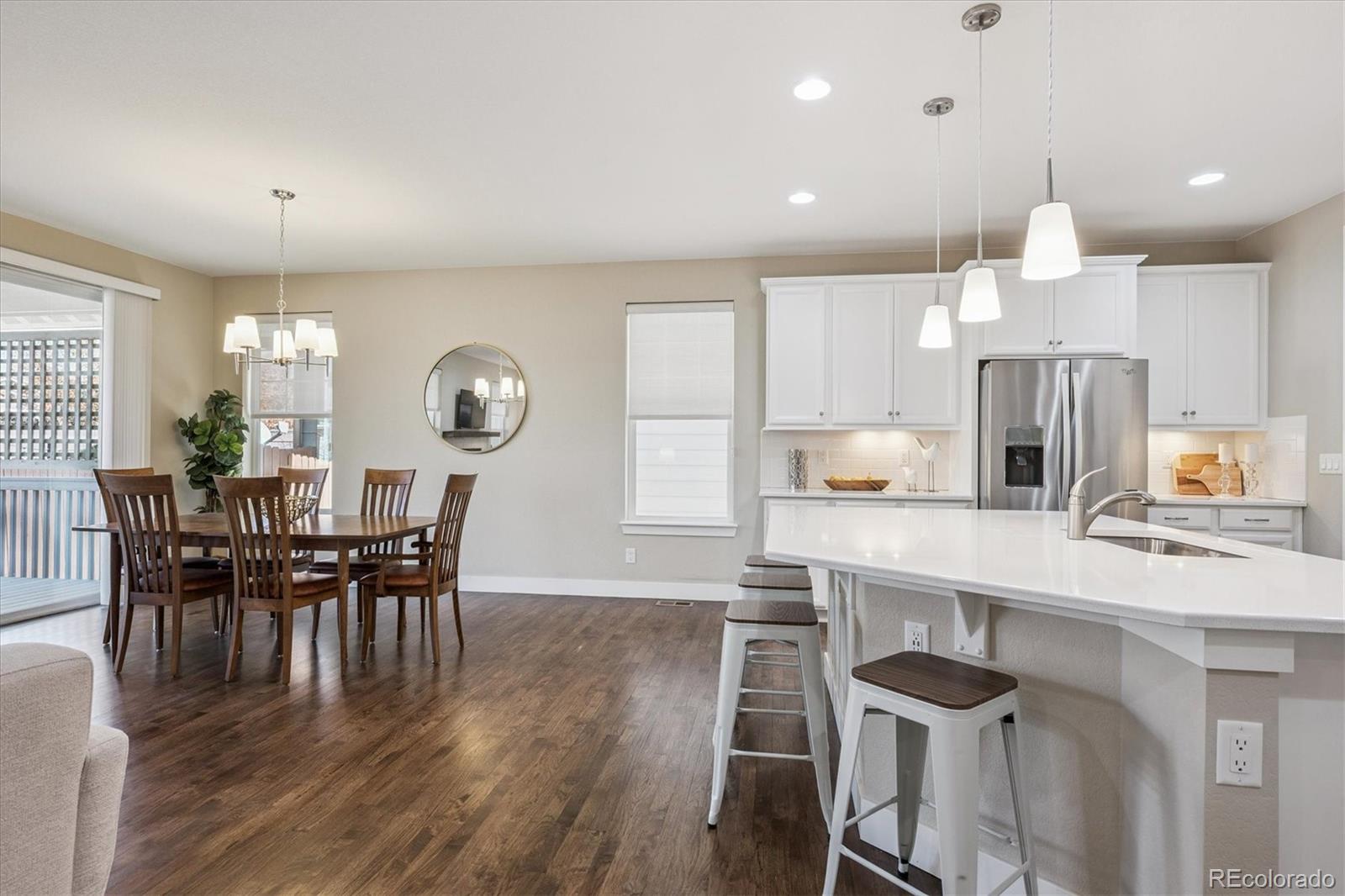6667 Club Villa Road Parker, CO 80134 - Photo 16 of 50 a view of a dining room with furniture and wooden floor