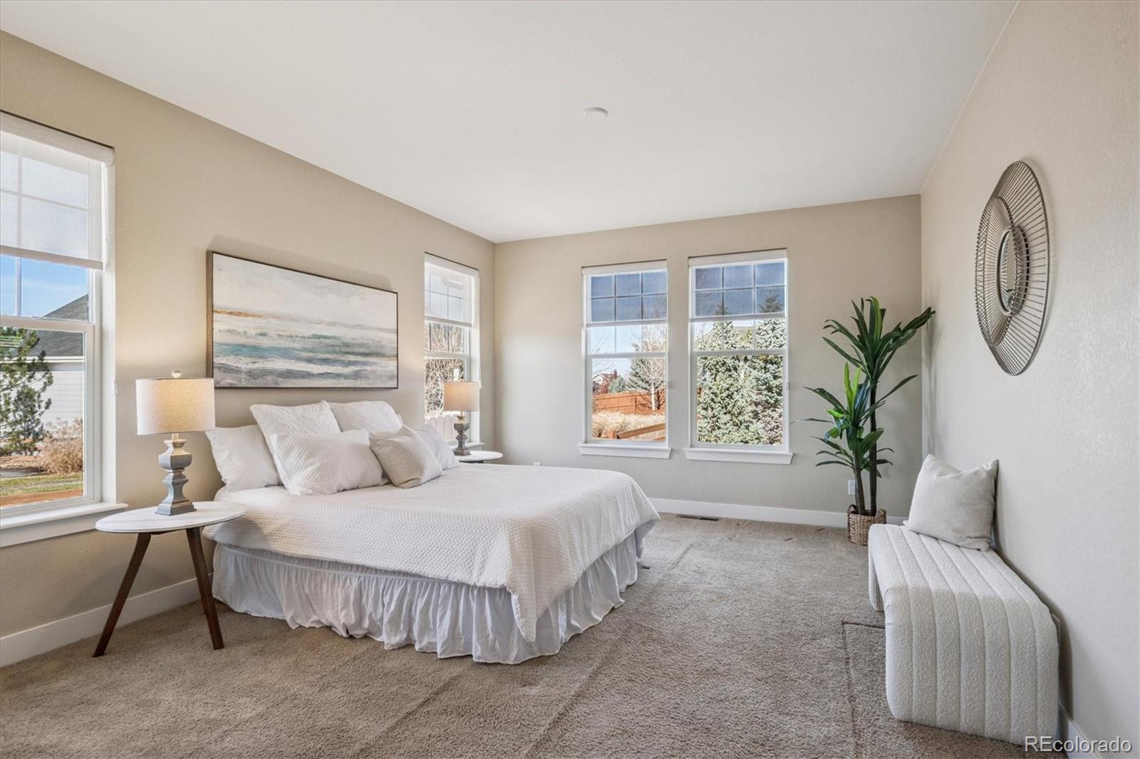 6667 Club Villa Road Parker, CO 80134 - Photo 22 of 50 a spacious bedroom with a large bed and a chandelier