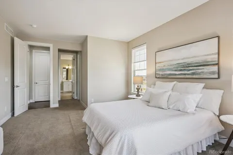 a bedroom with a bed and a painting