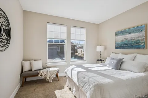 a bedroom with bed and a large window