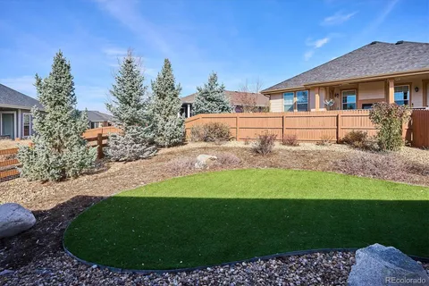 a view of backyard of house and car parked