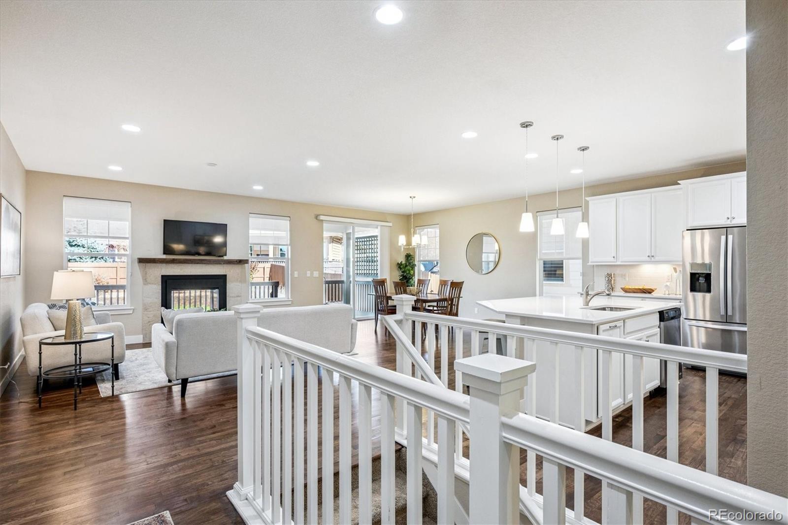 6667 Club Villa Road Parker, CO 80134 - Photo 4 of 50 a view of kitchen with furniture and wooden floor