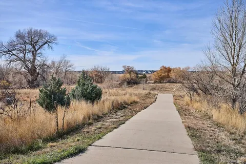 a view of a pathway with a wrought fence