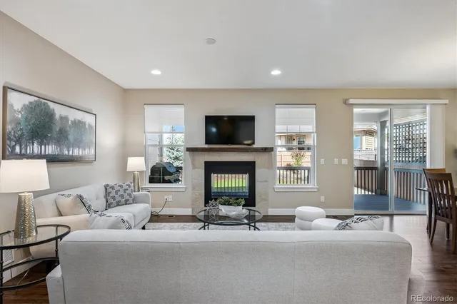 a living room with furniture a fireplace and a flat screen tv
