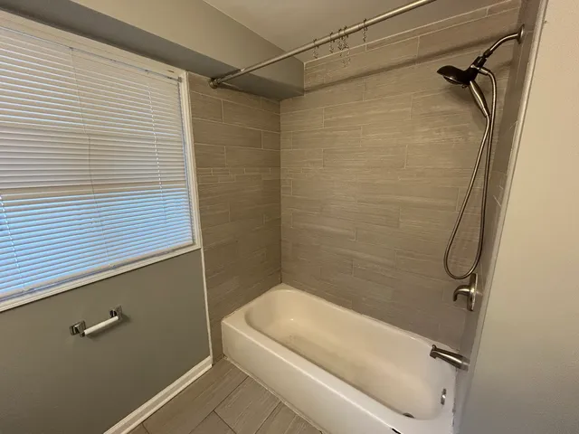 a bathroom with a white shower a toilet and a sink